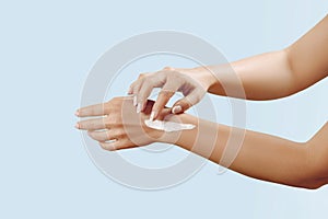 Beautiful Woman Hands. Female Hands Applying Cream, Lotion. Spa and Manicure concept. Soft skin, skincare concept.