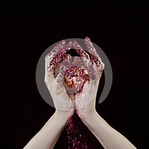 Beautiful woman hands with glitter holding apple close up