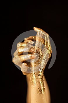 Beautiful woman hands in gold, golden hands, glitter sensual glamour luxury