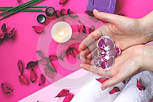 Beautiful woman hands with manicured nails, holding orchid flower