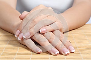 Beautiful woman hands and nails with perfect french manicure