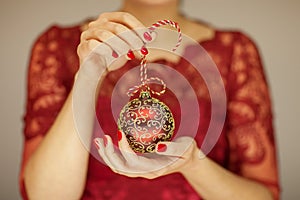 Beautiful woman hands with perfect nail polish holding christmas decorations