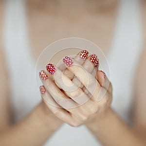 Beautiful woman hands with red nail polish art