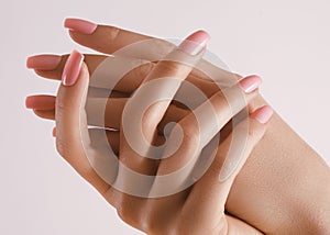 Beautiful Woman Hands. Soft skin, spa skincare concept. Female Hands Applying Cream or Lotion. Hands with pink manicure