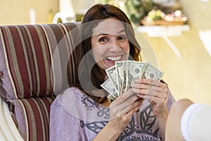 Beautiful woman happy with cash at home