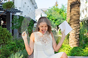 Beautiful woman is happy because of crazy idea which she has during writing some thoughts