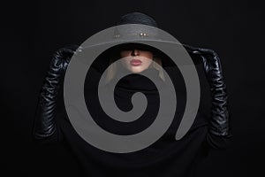 Beautiful woman in hat and leather gloves.halloween witch