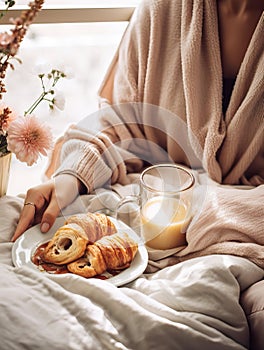 Beautiful woman having breakfast in bed, home bedroom interior with bright morning light, healthy food on cozy decorated