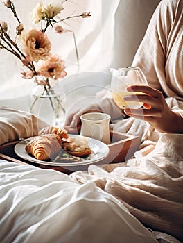 Beautiful woman having breakfast in bed, home bedroom interior with bright morning light, healthy food on cozy decorated