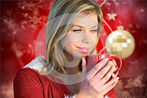 Beautiful woman having a cup of coffee during christmas time