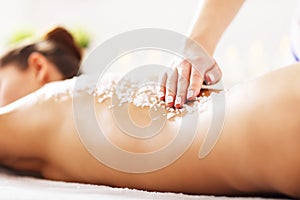 Beautiful woman having exfoliation treatment in spa photo