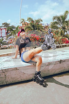 beautiful woman having fun with roller skates in spring photo