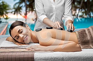 beautiful woman having hot stone massage at spa