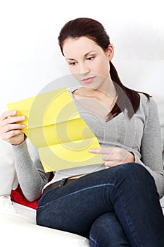 Beautiful woman having a look at the documents.