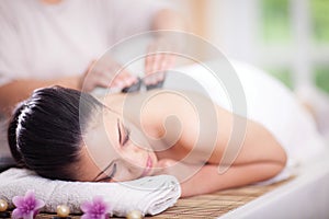 Beautiful woman having a wellness back massage at spa salon