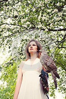 Beautiful Woman with Hawk on Blossom