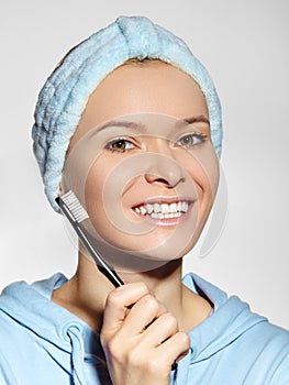 Beautiful Woman in Headband with Great Teeth holding Tooth Brush. Daily Routine Teethcare Treatment for Happy Smile