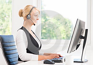 Beautiful woman in headset working in call center