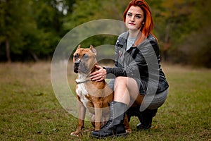 Beautiful woman and her dog in fall park