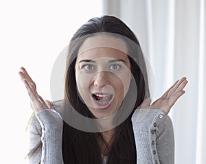 Beautiful woman with her face in astonishment photo