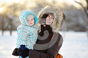 Beautiful woman and her little grandson at the winter