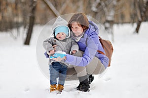 Beautiful woman and her little grandson at the winter