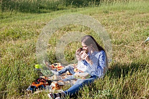 Beautiful woman with her son on a picnic