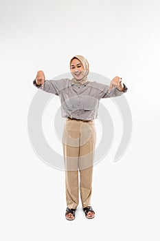 a beautiful woman with hijab standing and pointing down