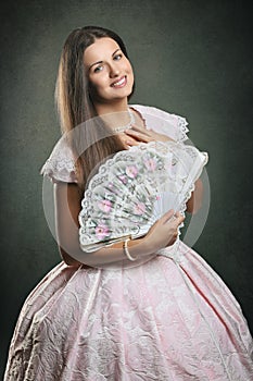 Beautiful woman historical dress with floral fan