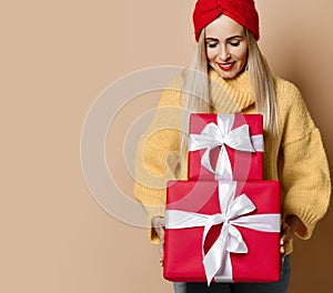 Beautiful woman hold red Christmas or birthday red presents gift boxes for new year celebration