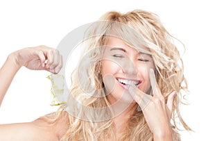 Beautiful woman holding apple core and laughing.