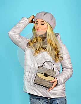 Beautiful woman holding bag. Autumn trendy outfit woman in stylish beret. leather handbag. Beauty and fashion. Stylish