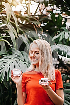 Beautiful woman holding beauty product