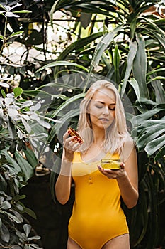 Beautiful woman holding beauty product