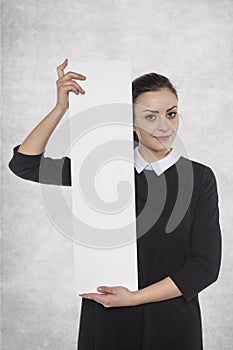 Beautiful woman holding a blank billboard, space for advertising