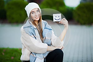 Beautiful woman holding cards with funny smile