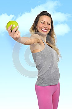 beautiful woman holding green apple fruit in healthy natural nutrition and fitness concept