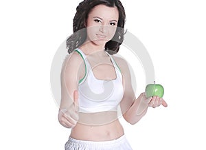 Beautiful woman holding green Apple shows thumb up