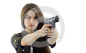 Beautiful woman holding a gun on white background