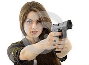 Beautiful woman holding a gun on white background
