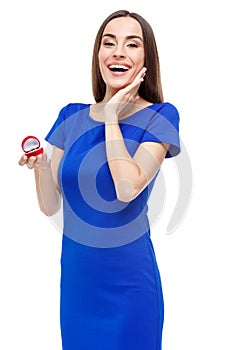 Beautiful woman holding heart shaped box with ring