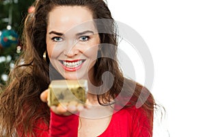 Beautiful woman holding out Christmas gift
