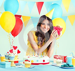 Beautiful woman holding a present at her birthday