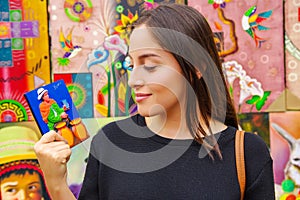 Beautiful woman holding a souvenir in a shopstore in Banos, Ecuador. Banos is a small touristy town, which is mainly