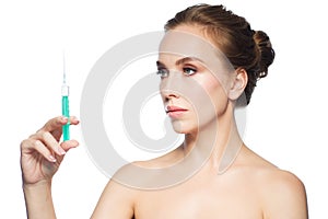 Beautiful woman holding syringe with injection