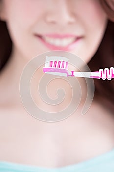 Beautiful woman holding tooth brush