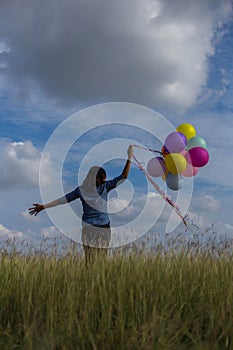 Beautiful woman Holding a transparent ball in the grass field photo