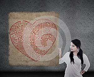 Beautiful woman holds heart maze map