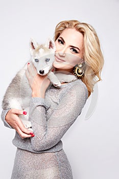 Beautiful woman hug pets dog makeup dress blond
