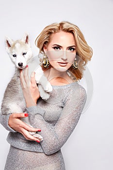 Beautiful woman hug pets dog makeup dress blond